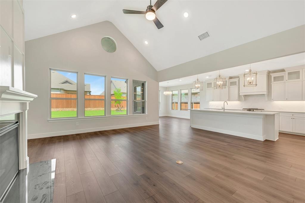 11460 Wulstone Road Fort Worth, TX 76052 - Photo 3 of 40 a view of an empty room with a window and wooden floor