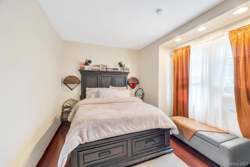 89-13 84th Street Queens, NY 11421 - Photo 29 of 34 Bedroom featuring wood-finish flooring, recessed lighting, and a window with blinds