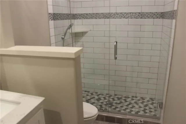 an empty room with windows and fireplace