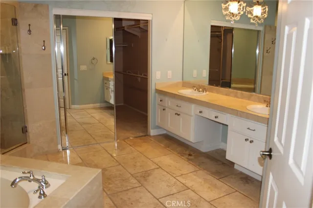 a bathroom with a sink a bathtub and shower