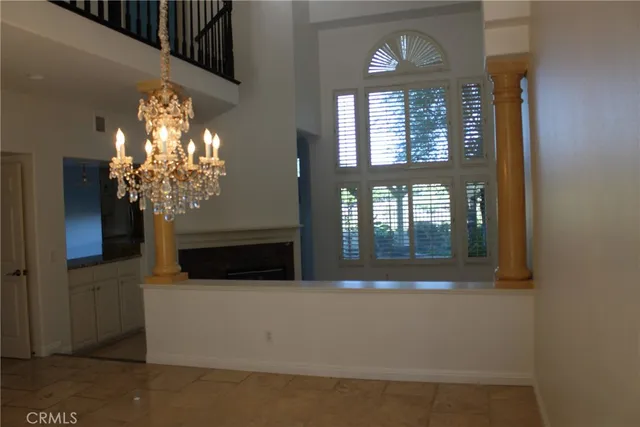 a living room with fireplace and a large window