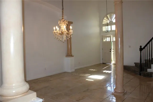 a view of an empty room with a fireplace and a window