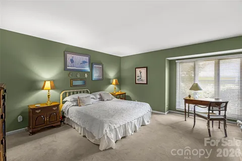 a bedroom with a bed and dresser