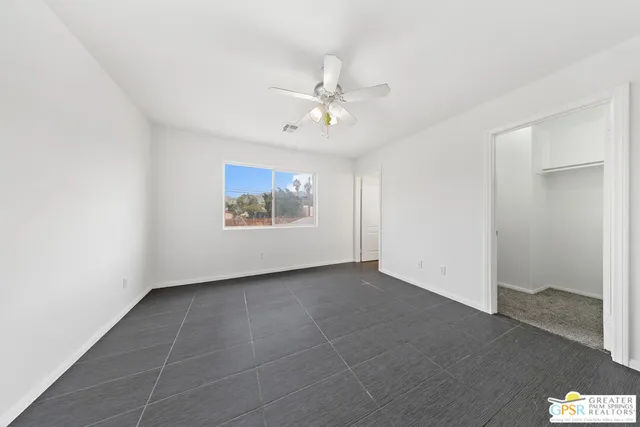 a bathroom with a granite countertop sink a toilet and bathtub