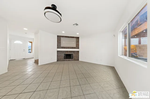 a kitchen with stainless steel appliances kitchen island granite countertop a refrigerator a sink and dishwasher