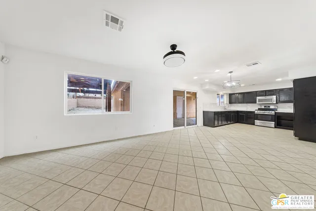 a kitchen with stainless steel appliances granite countertop a sink and stove top oven