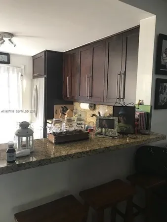 a kitchen with sink cabinets and window