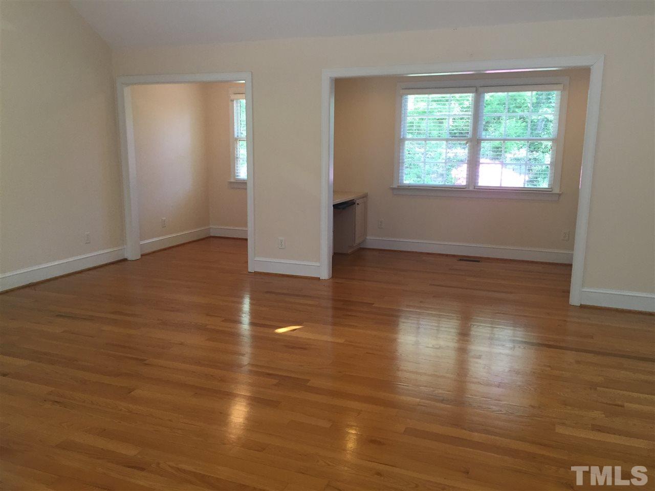 1745 Brooks Avenue Raleigh, NC 27607 - Photo 8 of 22 an empty room with wooden floor and windows