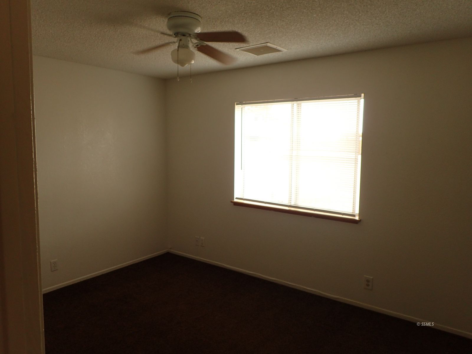 941 West Perdew Avenue Ridgecrest, CA 93555 - Photo 11 of 12 an empty room with a window and a fan