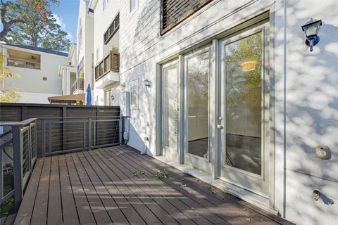 a view of a balcony with wooden floor and iron stairs