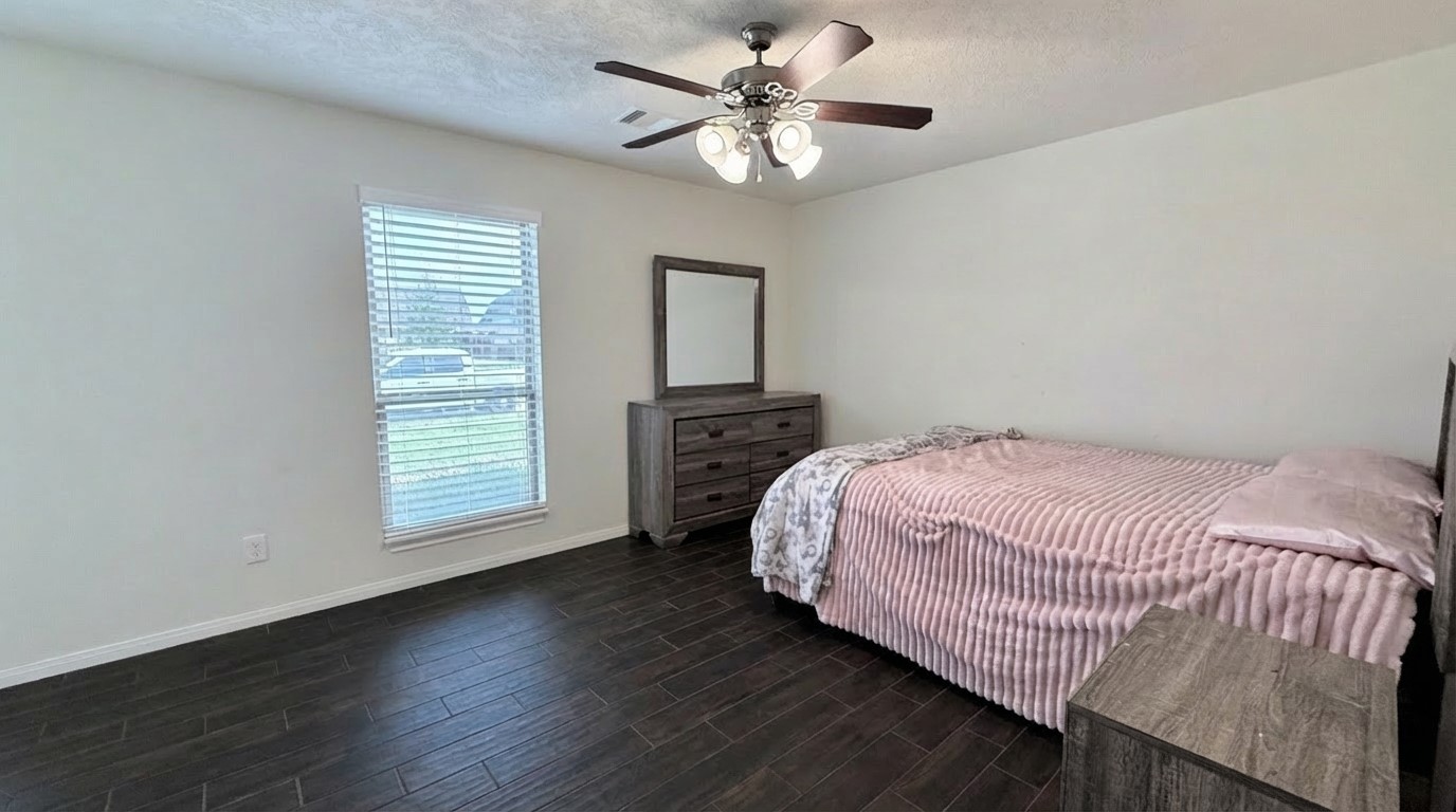2504 Rosa Rita Drive League City, TX 77573 - Photo 12 of 44 a bedroom with a bed and a chandelier