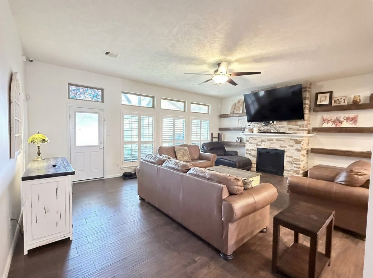 2504 Rosa Rita Drive League City, TX 77573 - Photo 16 of 44 a living room with furniture a flat screen tv and a fireplace