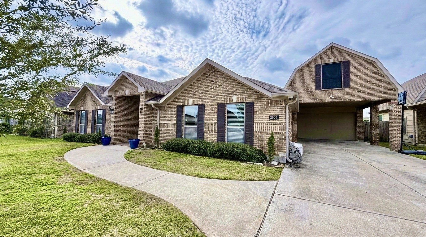 2504 Rosa Rita Drive League City, TX 77573 - Photo 31 of 41 a front view of a house with a yard and garage
