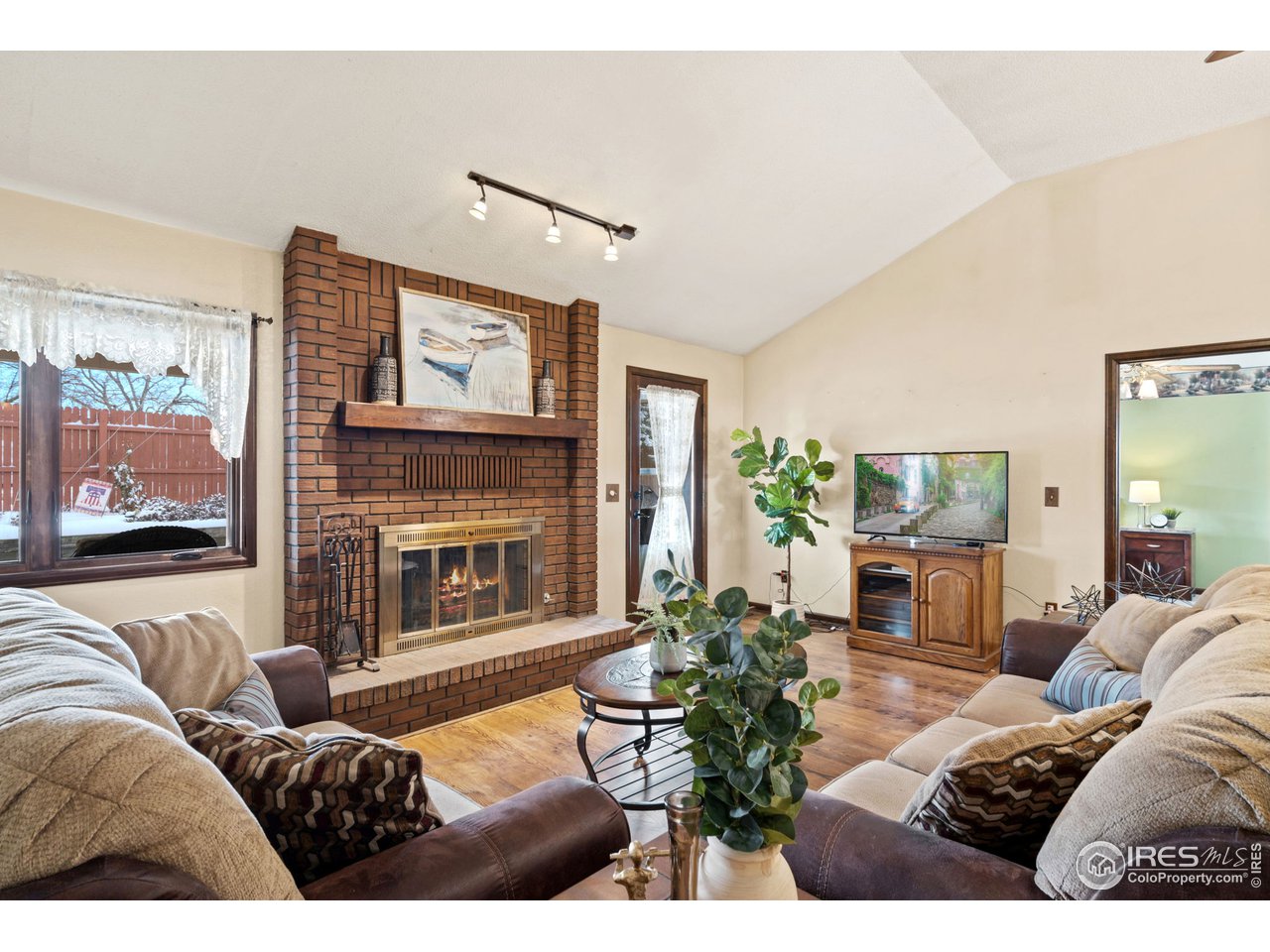 2736 25th Street Road Greeley, CO 80634 - Photo 4 of 29 Living Room with Cozy Fireplace