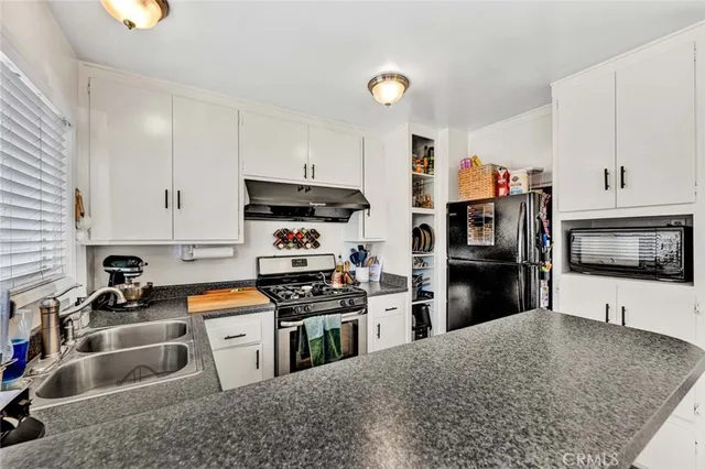 a living room with furniture a window and a flat screen tv