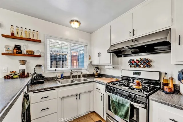 a kitchen with stainless steel appliances granite countertop a stove and a microwave