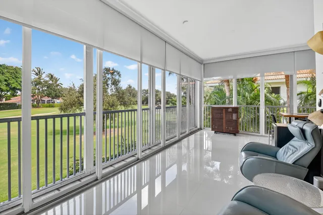 a bedroom with furniture and a large window