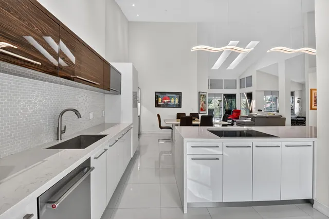 a spacious bathroom with a granite countertop sink a toilet and a mirror