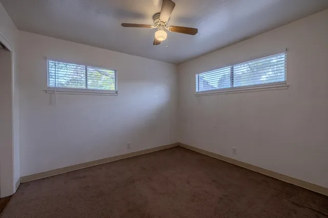 a view of empty room with ceiling fan