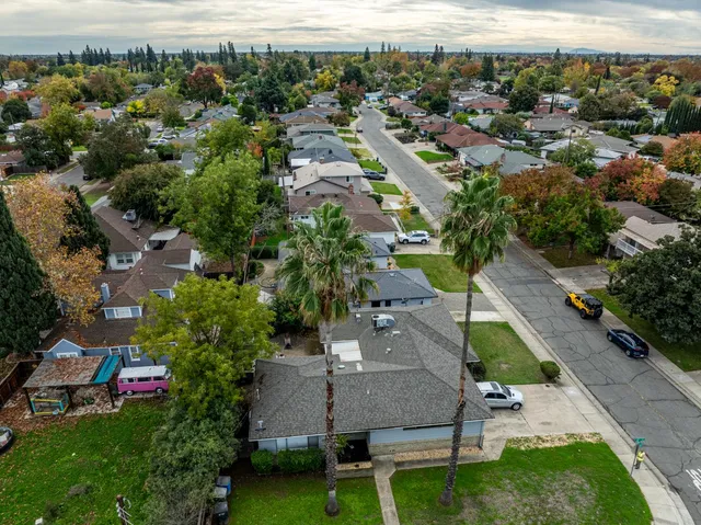 an aerial view of a house with a yard