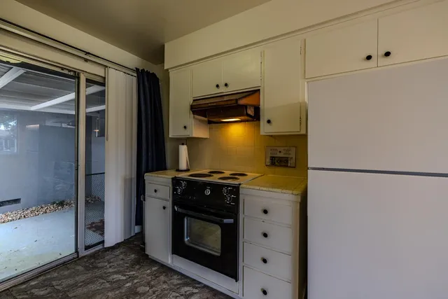 a kitchen with a stove and a refrigerator