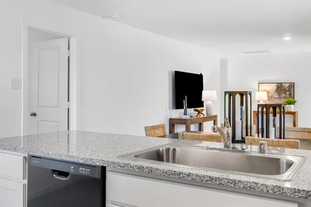 a kitchen with sink a counter top space and appliances