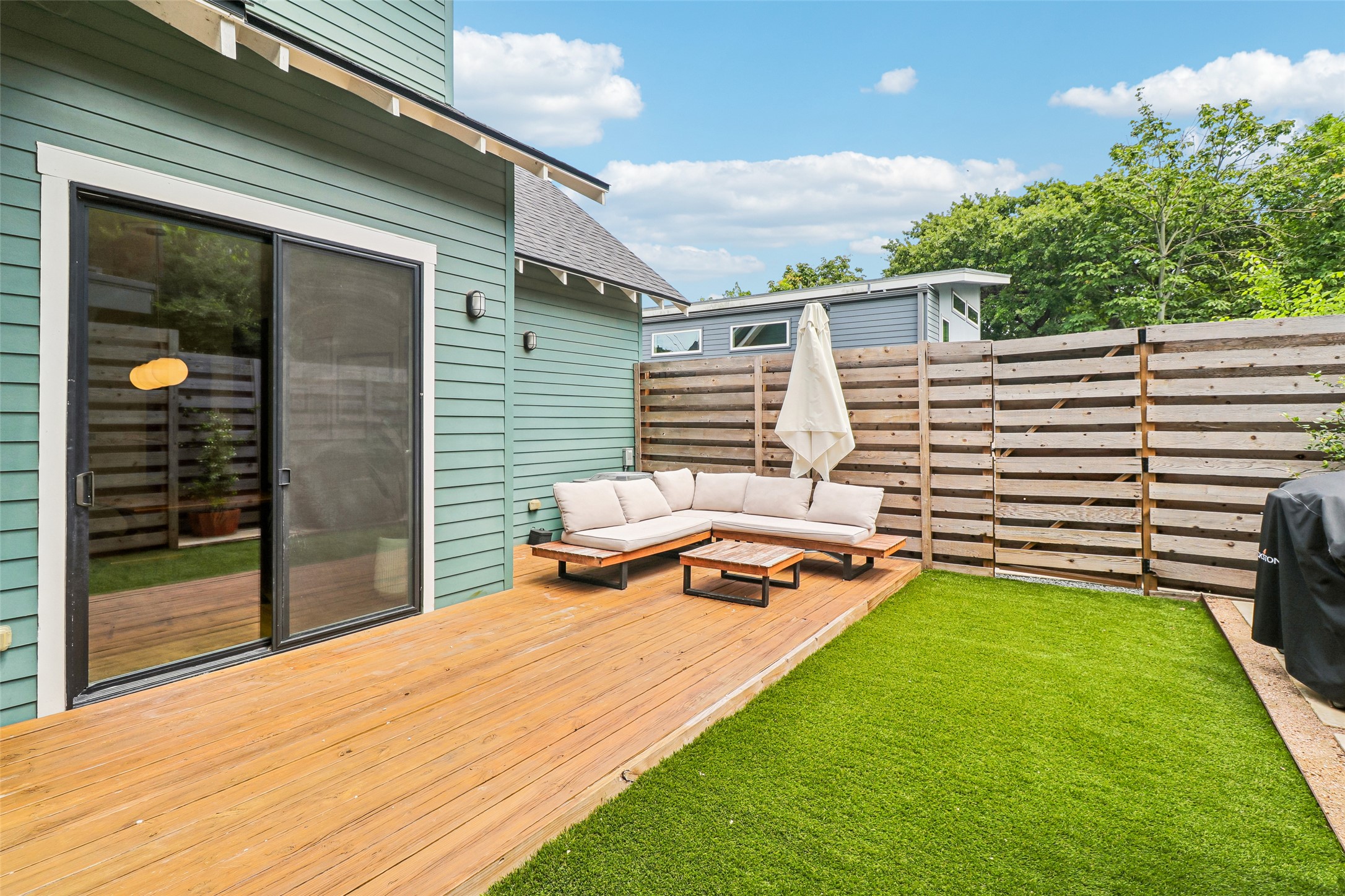 1706 Perez Street, Unit 1 Austin, TX 78721 - Photo 32 of 36 A private outdoor space features a spacious wood deck and lush artificial turf.