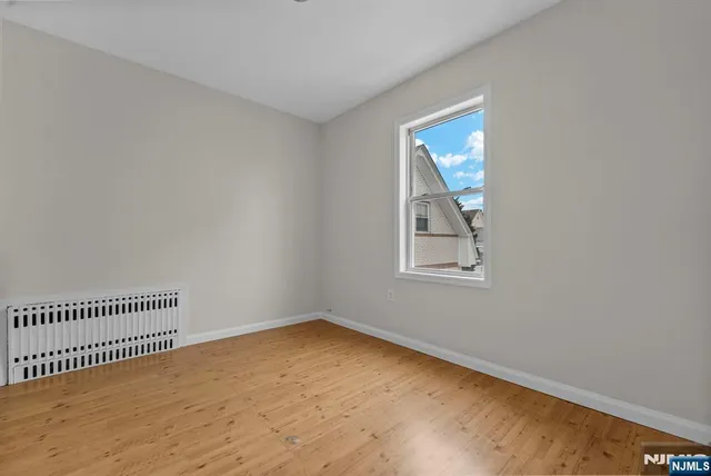 a view of a room with wooden floor and window