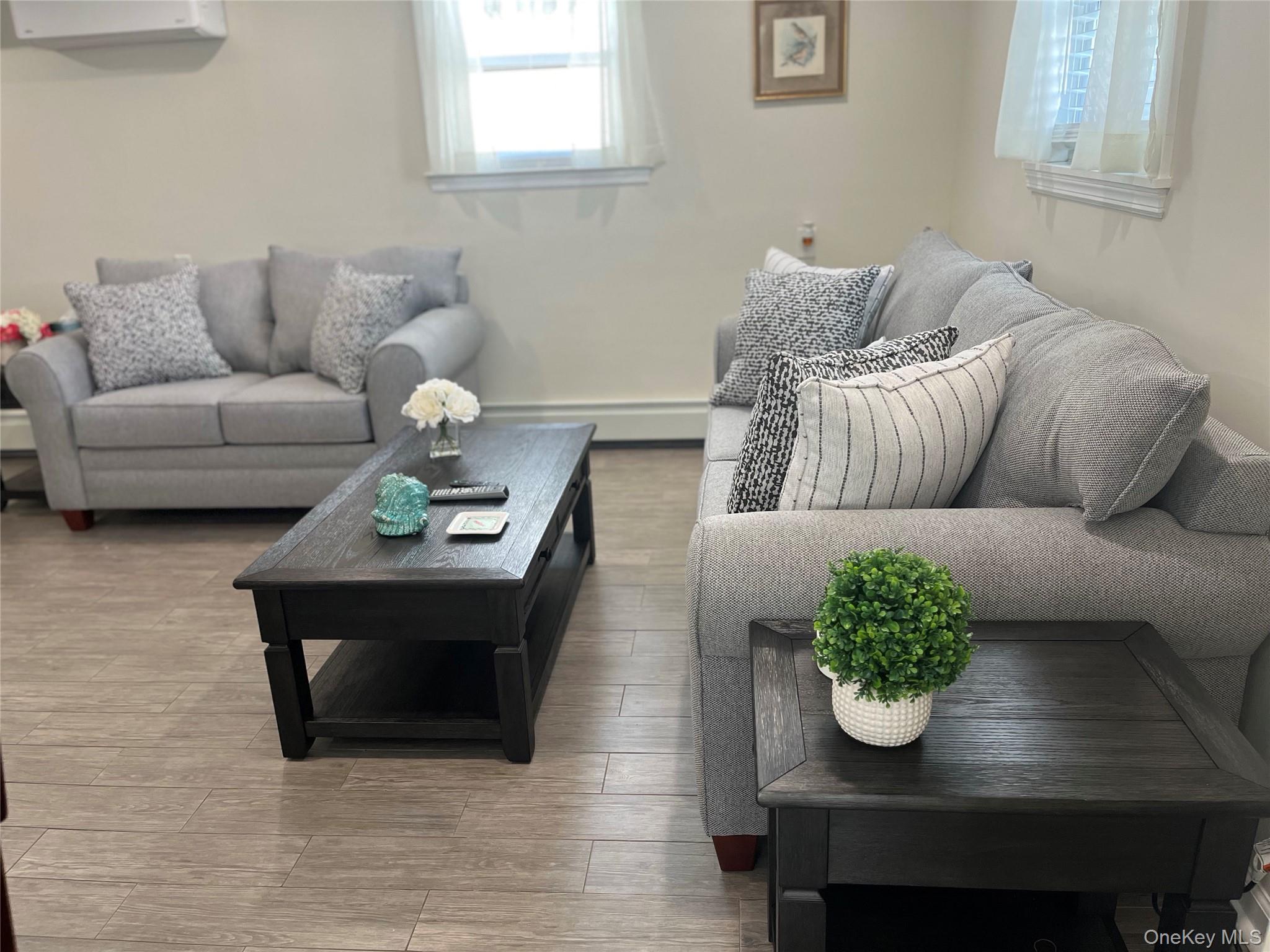 321 West Walnut Street, Unit 2 Long Beach, NY 11561 - Photo 6 of 13 a living room with furniture and wooden floor