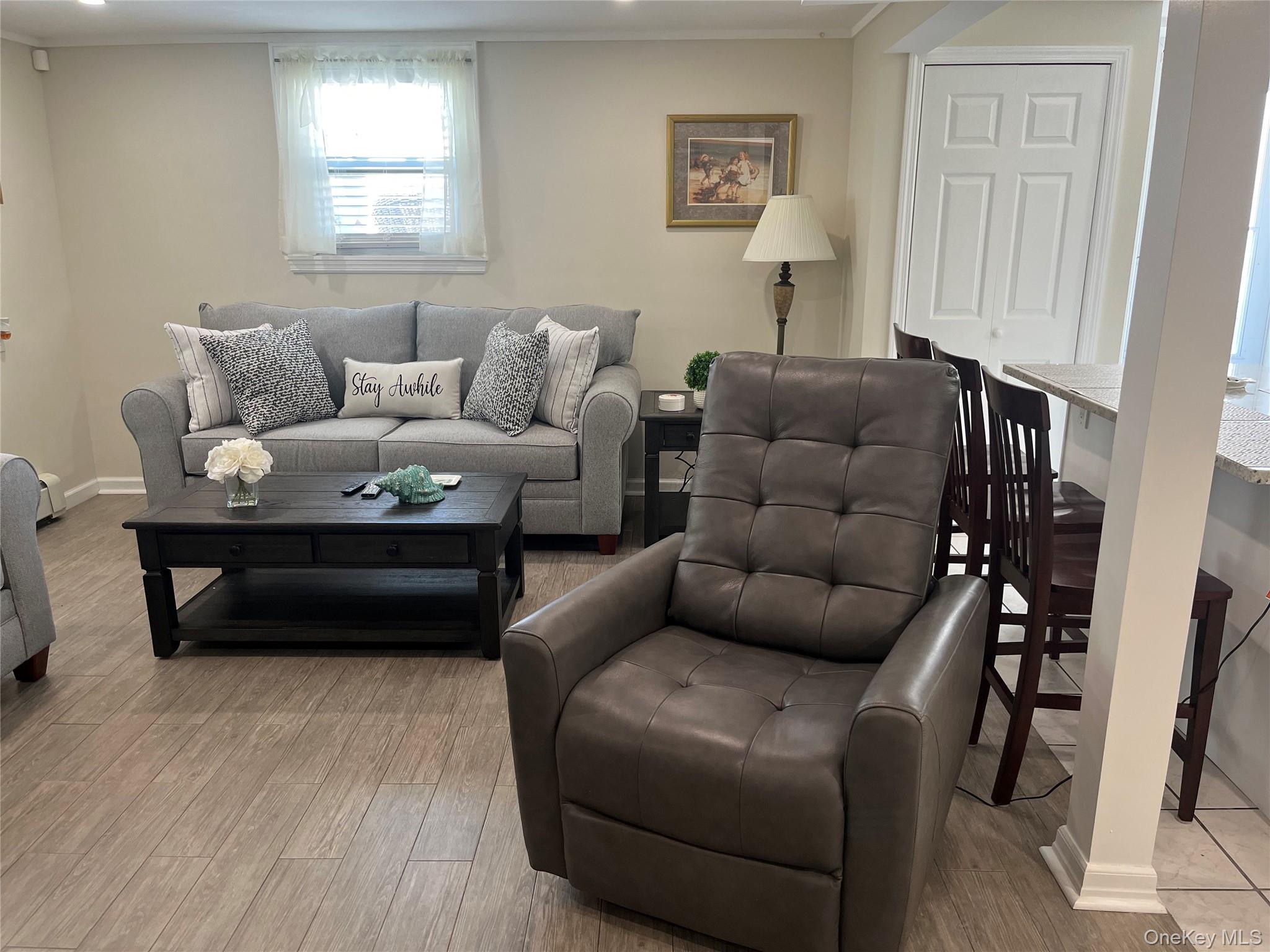 321 West Walnut Street, Unit 2 Long Beach, NY 11561 - Photo 7 of 13 a living room with furniture and a wooden floor
