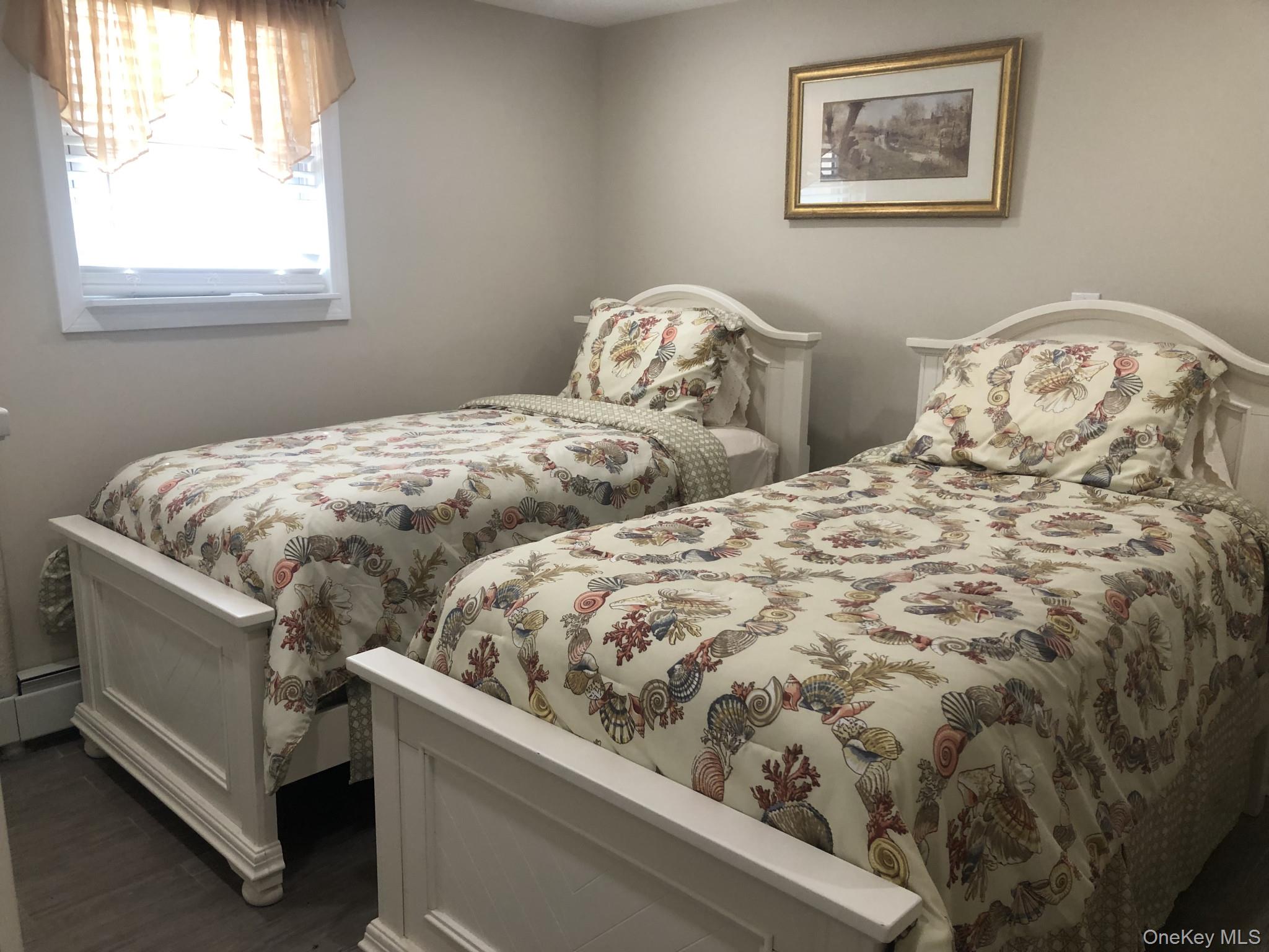 321 West Walnut Street, Unit 2 Long Beach, NY 11561 - Photo 8 of 13 a bedroom with two beds and a window