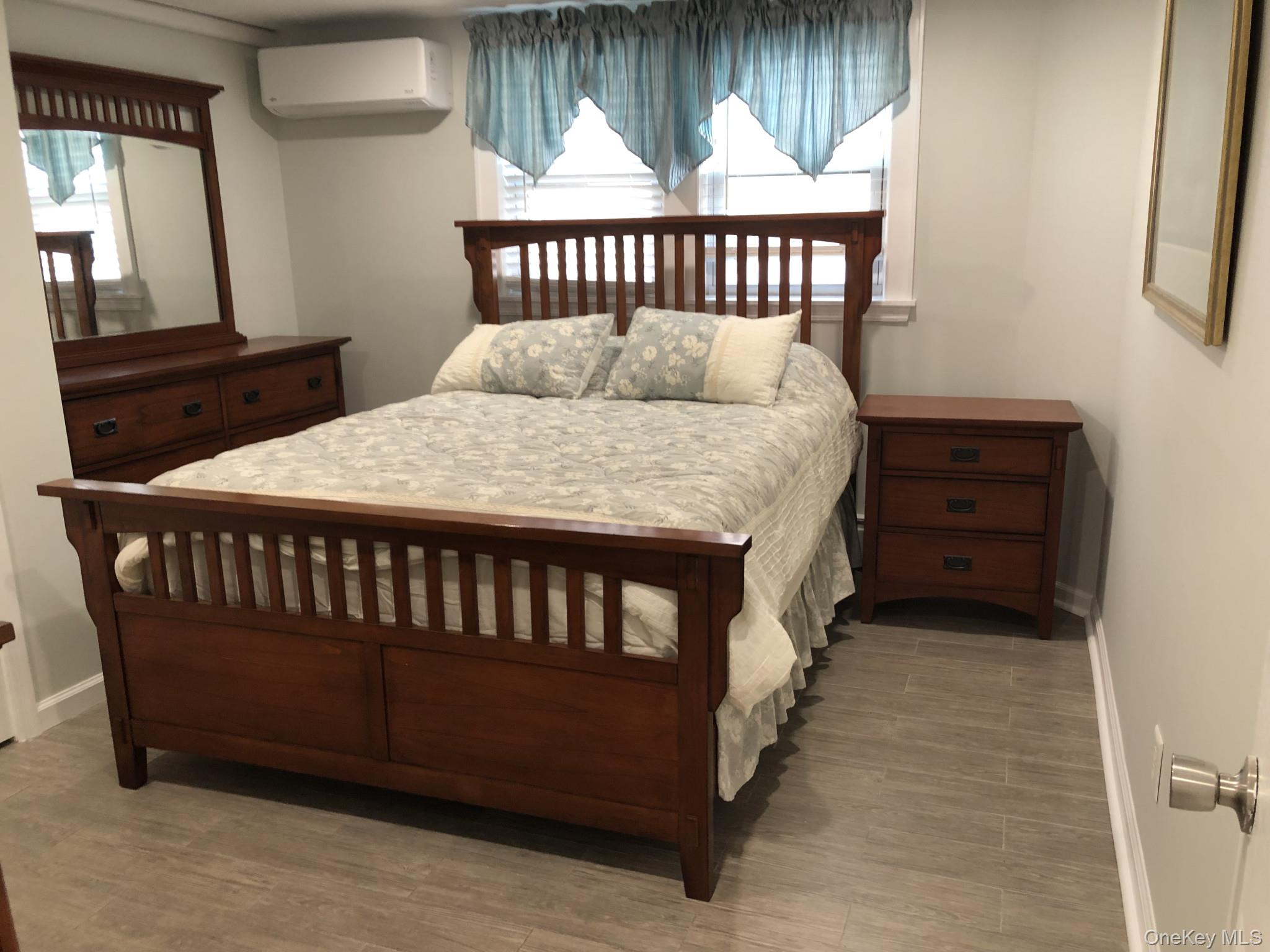 321 West Walnut Street, Unit 2 Long Beach, NY 11561 - Photo 9 of 13 a bedroom with a bed and window