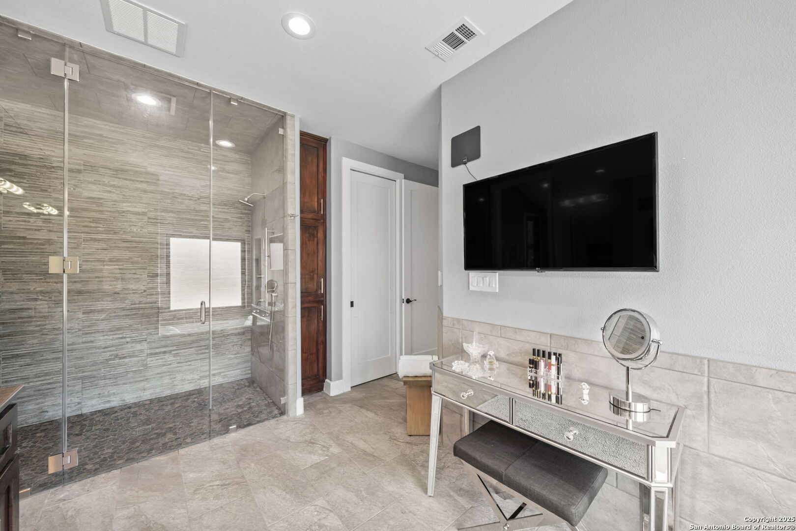 172 Bluff Street Dripping Springs, TX 78620 - Photo 16 of 39 a room with a chair a flat screen tv and a glass door