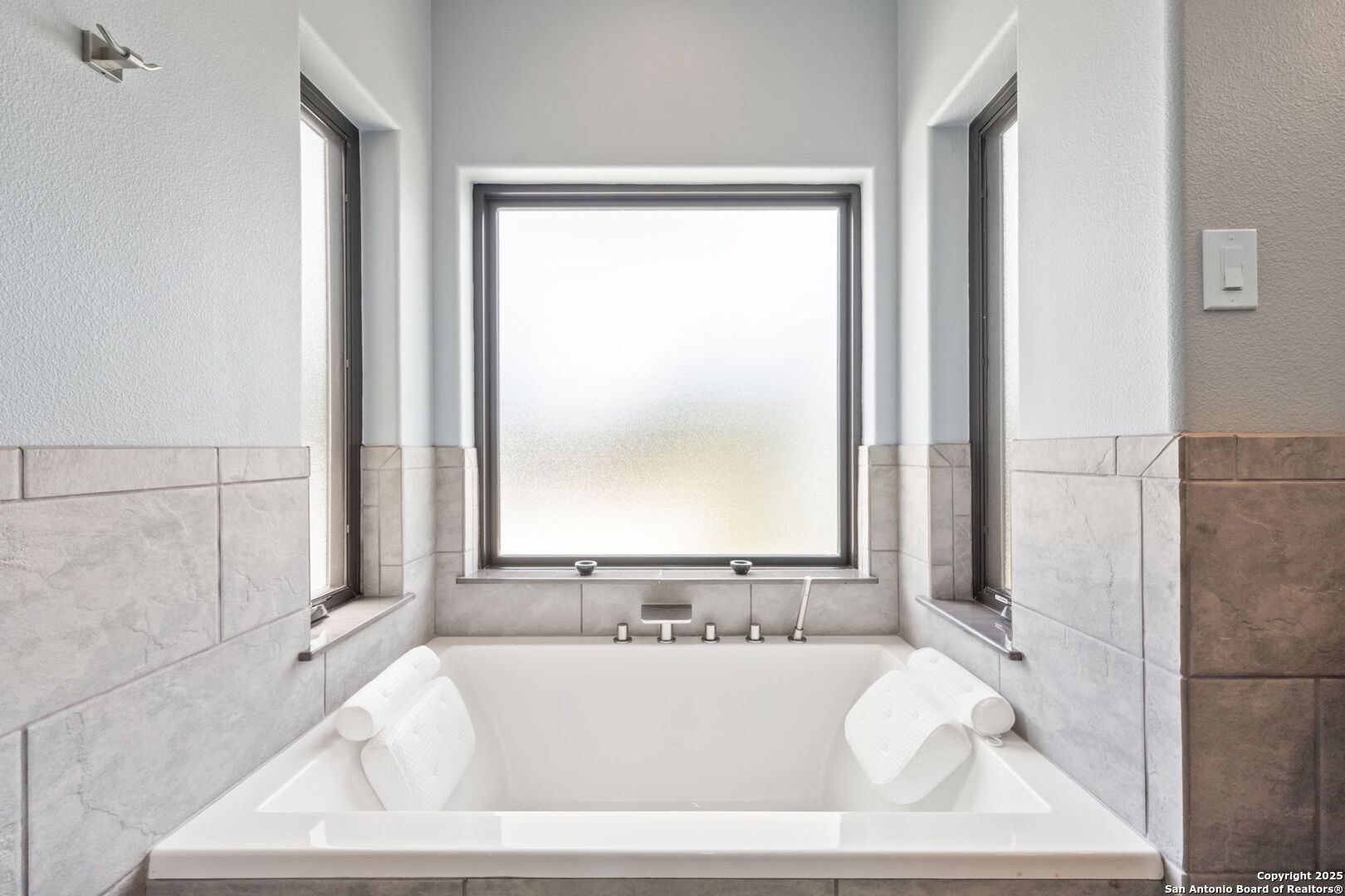172 Bluff Street Dripping Springs, TX 78620 - Photo 18 of 39 a bath tub sitting in a bathroom next to a window