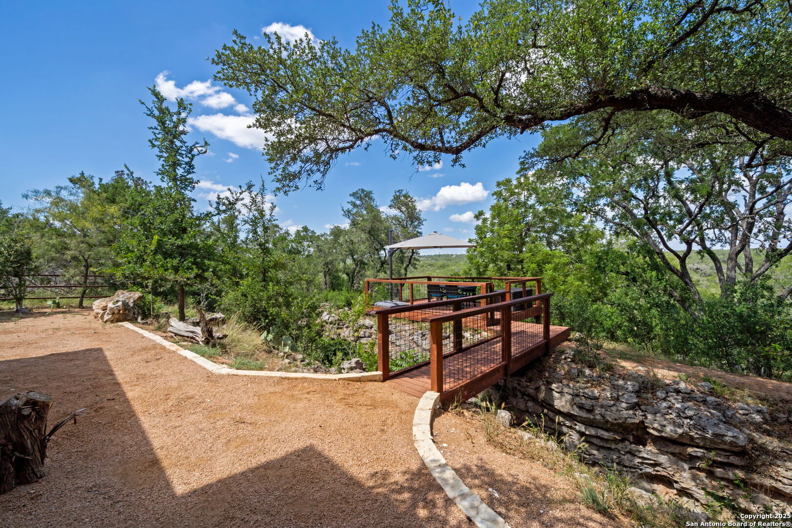 172 Bluff Street Dripping Springs, TX 78620 - Photo 22 of 39 a view of a bench in a backyard