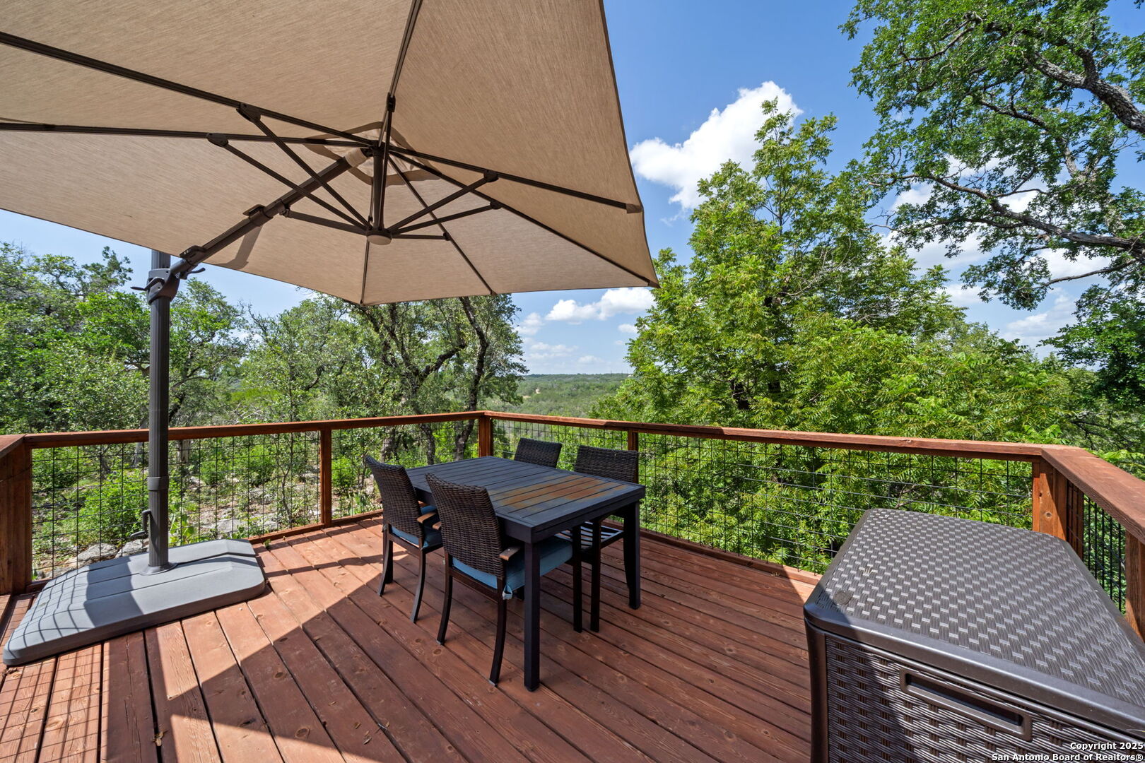172 Bluff Street Dripping Springs, TX 78620 - Photo 23 of 39 a view of a balcony with furniture and wooden floor