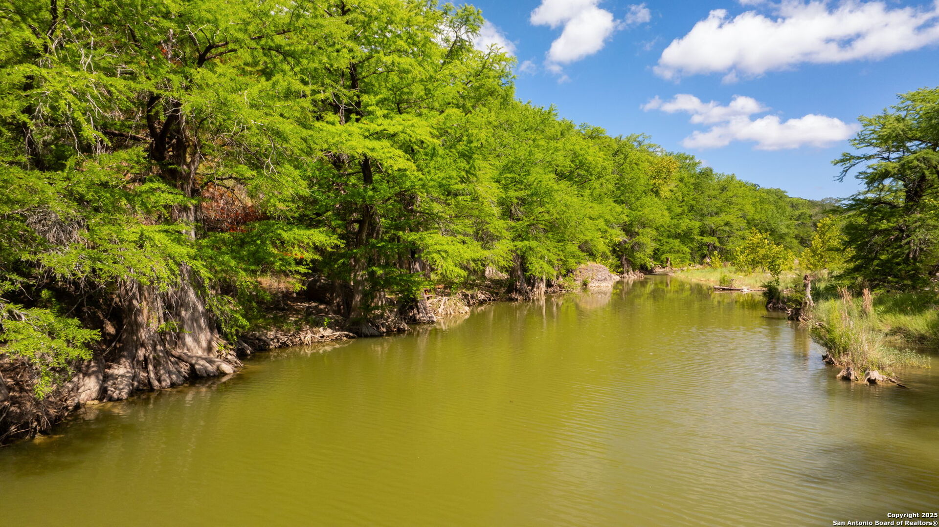 172 Bluff Street Dripping Springs, TX 78620 - Photo 30 of 39 a view of an ocean with a house in the background