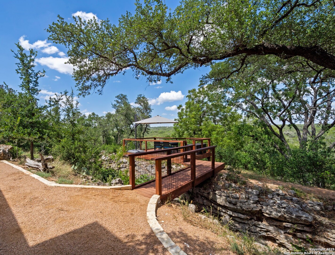 172 Bluff Street Dripping Springs, TX 78620 - Photo 33 of 39 a view of a bench in a backyard