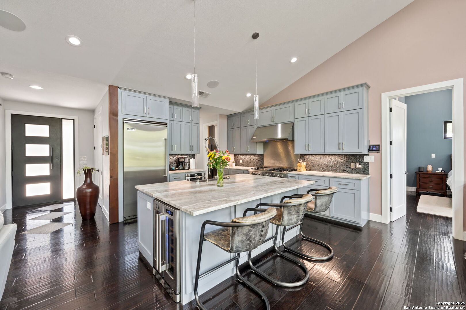 172 Bluff Street Dripping Springs, TX 78620 - Photo 9 of 39 a kitchen with a table chairs refrigerator and cabinets