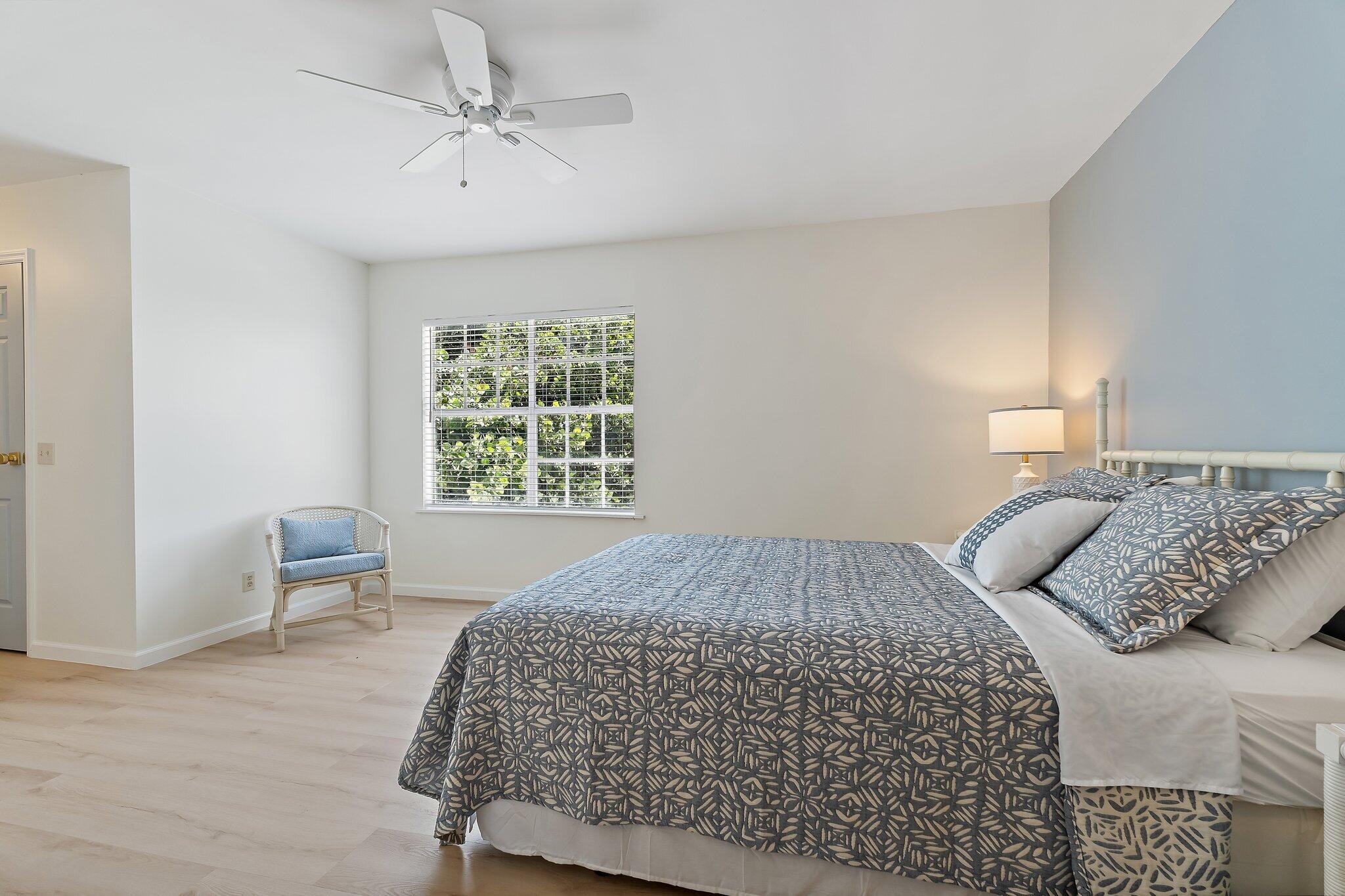 11830 Brier Patch Court Wellington, FL 33414 - Photo 16 of 34 a bedroom with a bed and chair