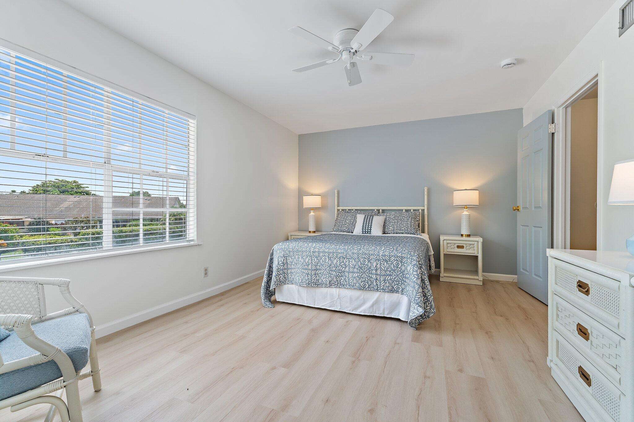 11830 Brier Patch Court Wellington, FL 33414 - Photo 17 of 34 a bedroom with a large bed and a window