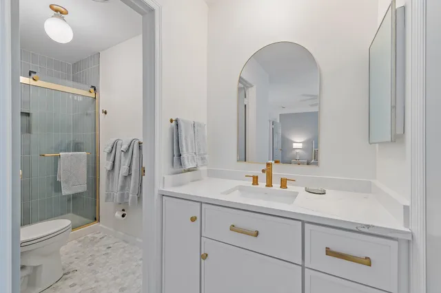 a bathroom with a double vanity sink mirror and shower