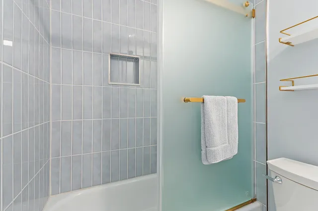 a bathroom with a shower and toilet