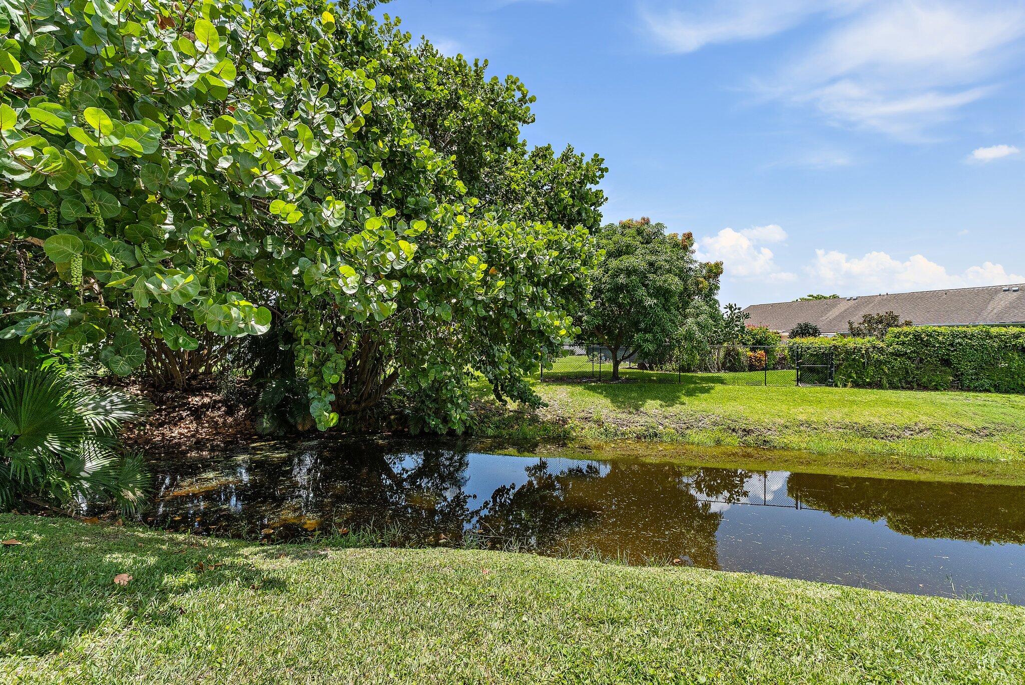 11830 Brier Patch Court Wellington, FL 33414 - Photo 29 of 34 a view of a lake with a yard