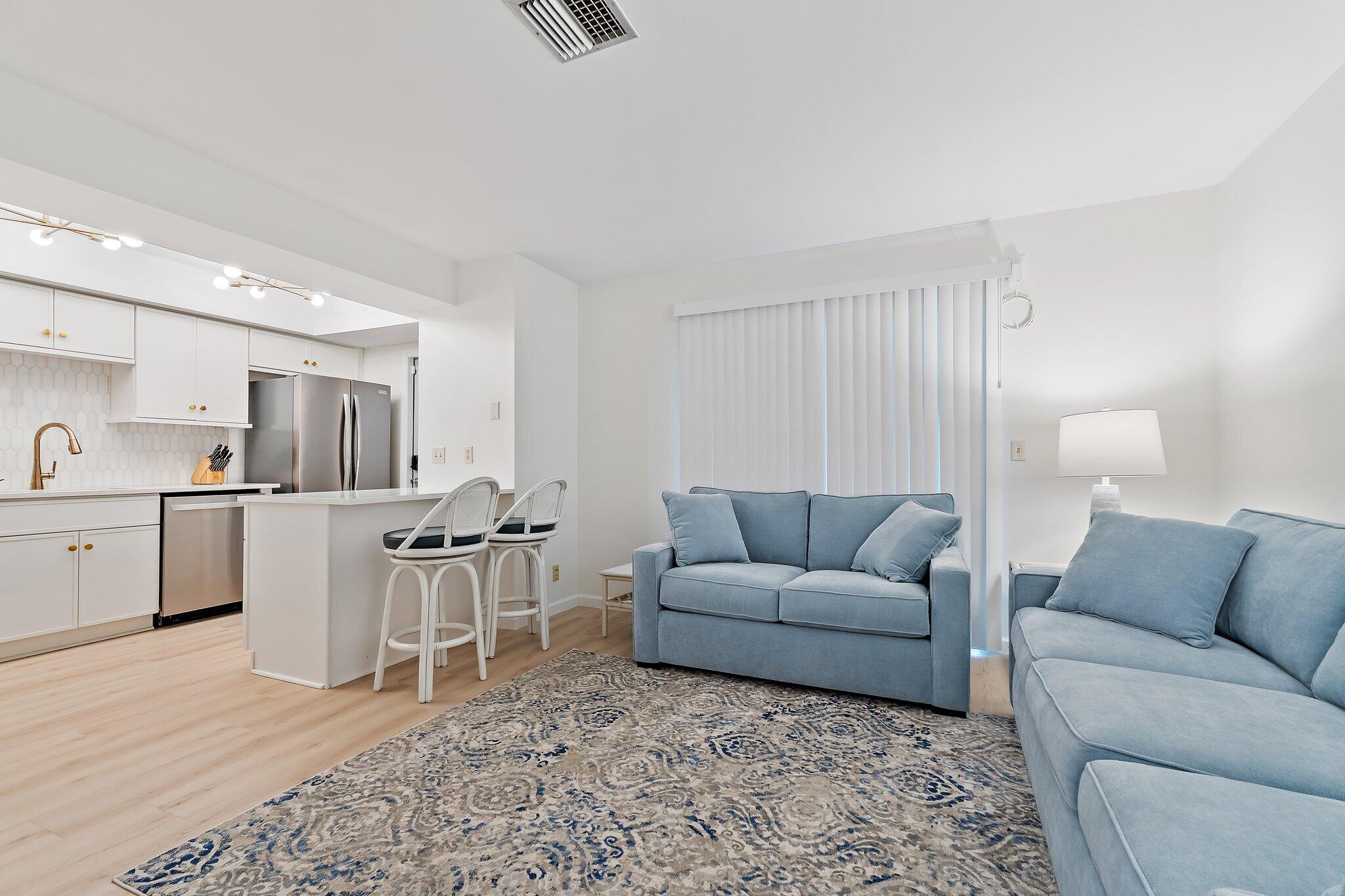 11830 Brier Patch Court Wellington, FL 33414 - Photo 7 of 34 a living room with furniture and view of kitchen