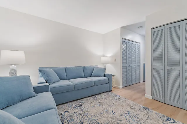 a living room with furniture a lamp and a rug