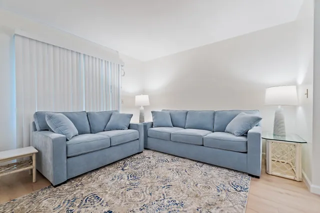 a living room with furniture a lamp and a window