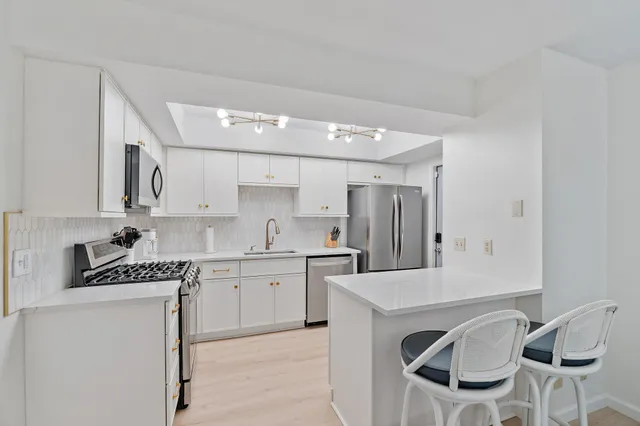 a kitchen with stainless steel appliances granite countertop a sink and cabinets