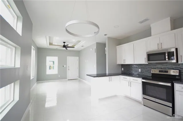 a kitchen with stainless steel appliances a white stove top oven and sink