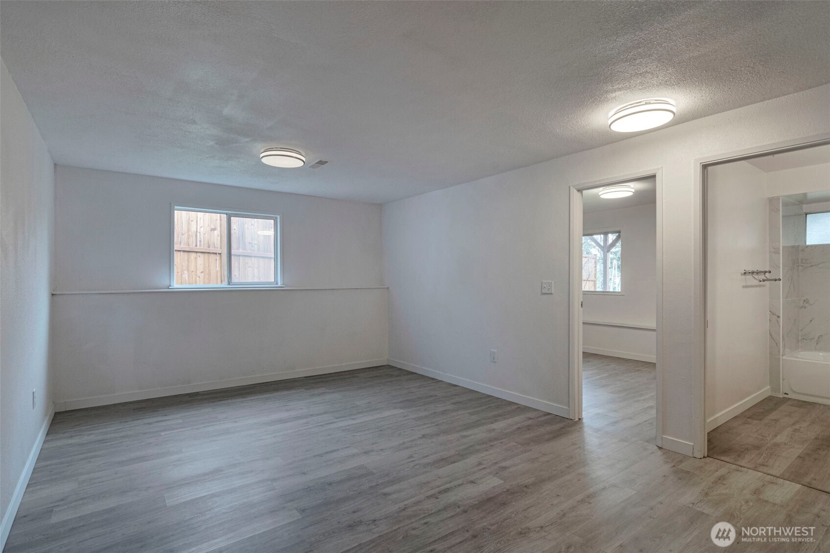 25810 129th Place Southeast Kent, WA 98030 - Photo 16 of 25 an empty room with wooden floor and windows